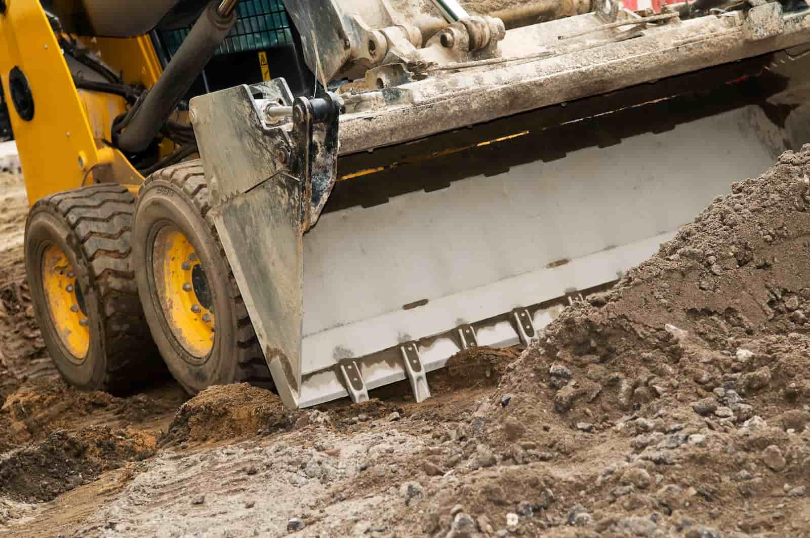 skid loader moving dirt